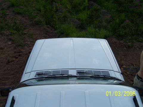 1995 Jeep Cherokee - A white 1995 Jeep Cherokee is seen from above, parked on a dirt embankment.