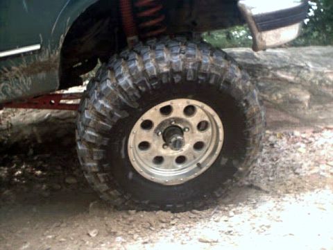 1996 Ford Bronco - This image focuses on the tire and suspension components of an off-road vehicle, suggesting it's built for challenging terrain.