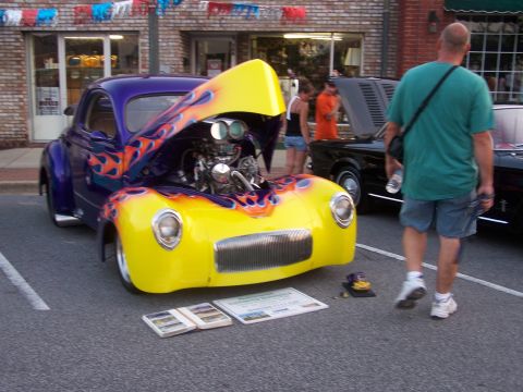 1973 Ford Ranchero - Custom hot rod with flame graphics and exposed engine at a car show.