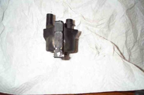 1988 Ford Bronco - A close-up view of a vehicle's distributor cap and rotor assembly, resting on a white cloth surface.