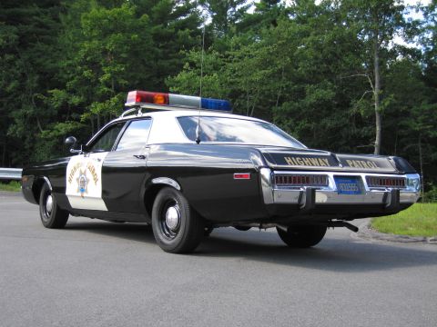1991 Ford LTD Crown Victoria - black-and-white Highway Patrol cruiser viewed from the rear with twin tail lamps and a visible license plate.