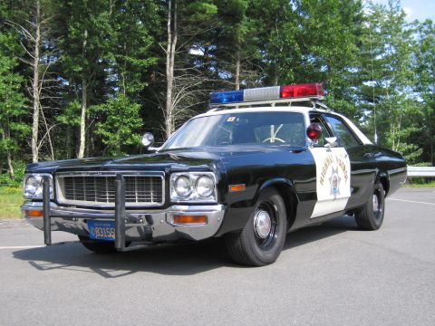1991 Ford LTD Crown Victoria - black-and-white Highway Patrol cruiser, front quarter view showing grille guard, lightbar and a visible front plate.