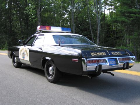 1991 Ford LTD Crown Victoria - Rear three-quarter view of a black Highway Patrol police sedan with HIGHWAY PATROL lettering and California plate 831555.