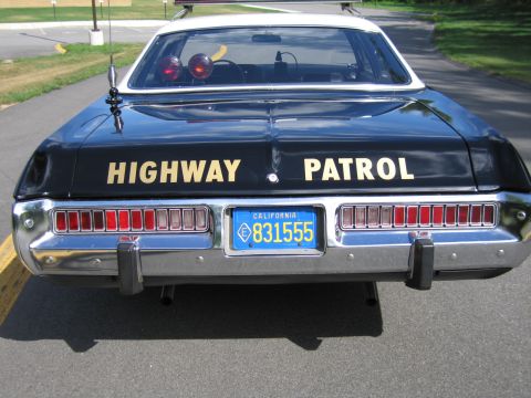 1991 Ford LTD Crown Victoria - Rear view of a Highway Patrol police sedan with twin rear-deck lights, HIGHWAY PATROL lettering and California plate 831555.