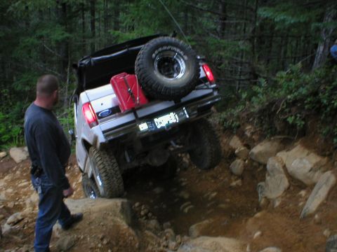 1978 Ford Bronco - A white Ford Bronco navigates a challenging rocky terrain off-road.