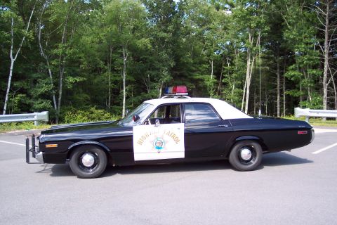 1991 Ford LTD Crown Victoria - Full side profile of a black-and-white California Highway Patrol sedan with white roof, door star, and roof emergency lights.