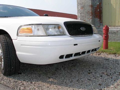 2001 Ford Crown Victoria - Front view of a white 2001 Ford Crown Victoria parked on a gravel surface.