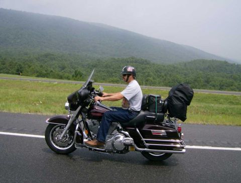 2005 BMW R1200CA ABS - Motorcyclist travels on a highway with a scenic mountain backdrop.
