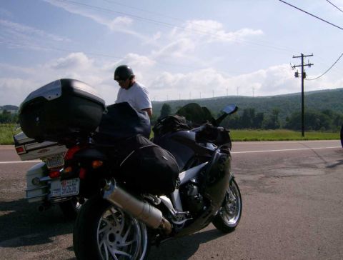 2005 BMW R1200CA ABS - A motorcycle is parked on the side of the road, loaded with luggage, with another motorcycle nearby.