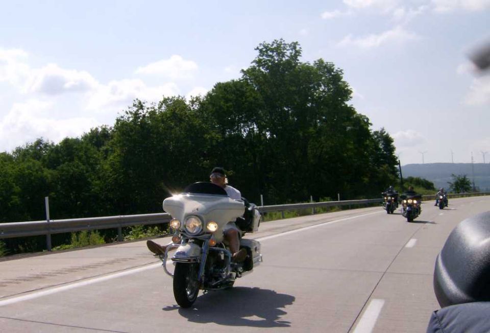 White touring motorcycle with rider on highway
