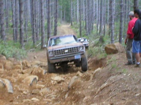 1978 Ford Bronco - A Chevrolet K5 Blazer navigates a challenging, rocky off-road trail with another vehicle following behind.