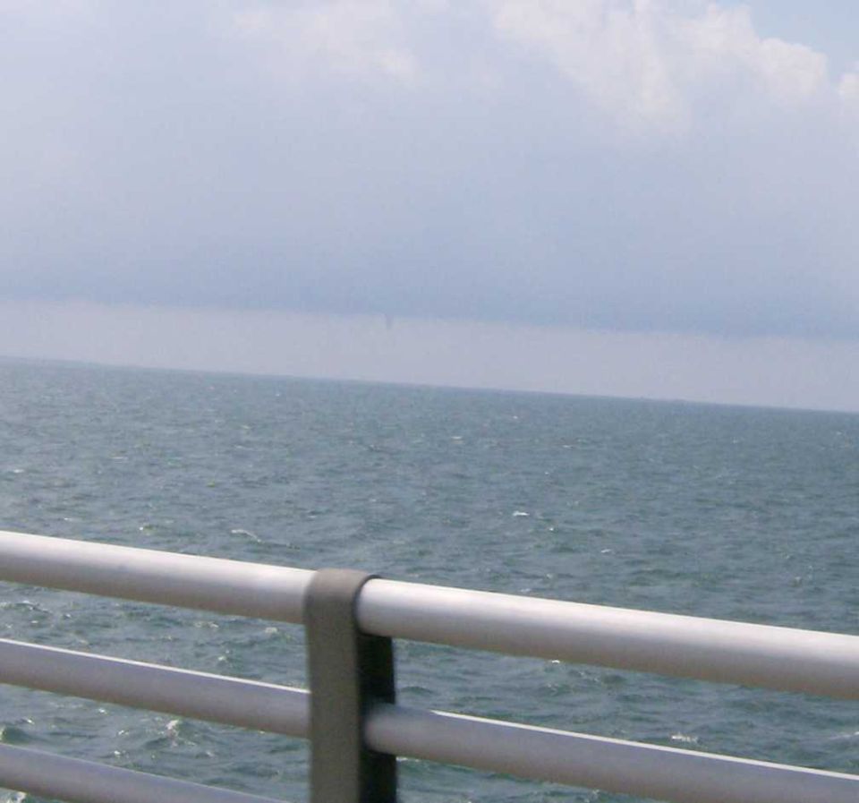 Water and sky seen from a bridge railing