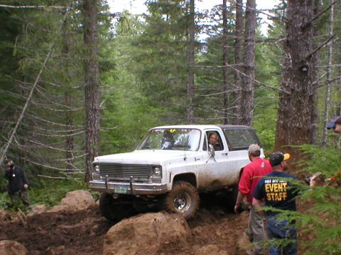 1978 Ford Bronco - A 1975 Chevrolet K5 Blazer navigates a challenging off-road course through a wooded area.