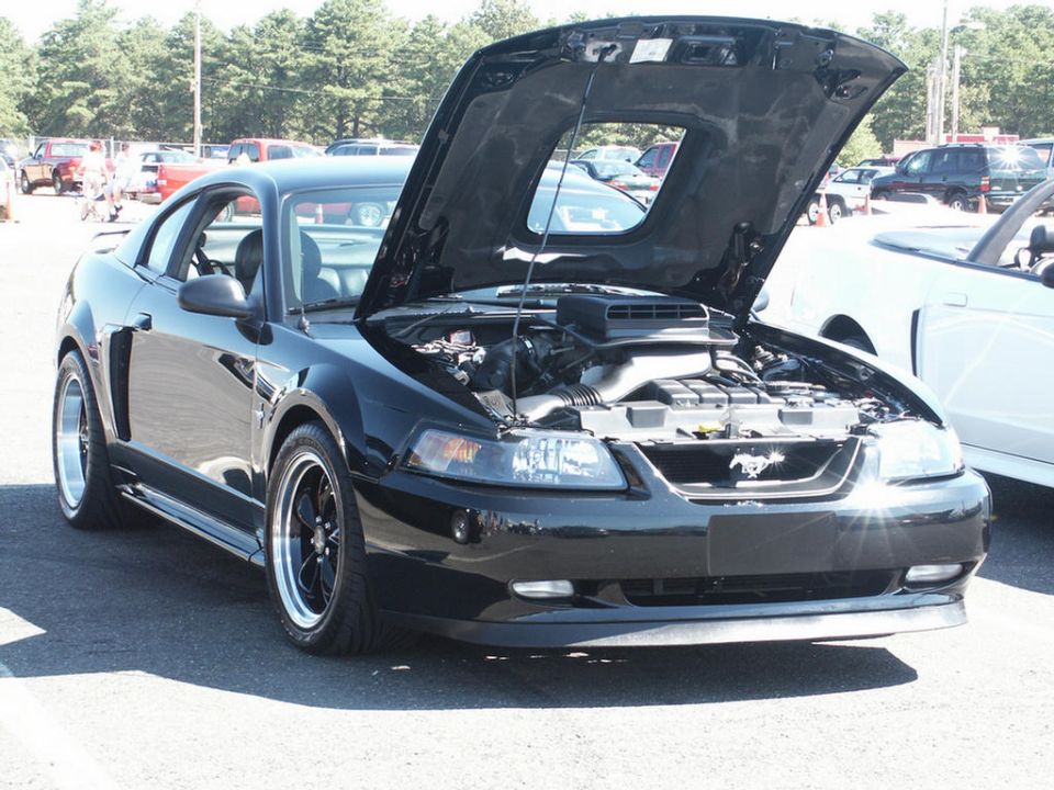 Black 2001 Ford Mustang with hood open, showing engine and scoop
