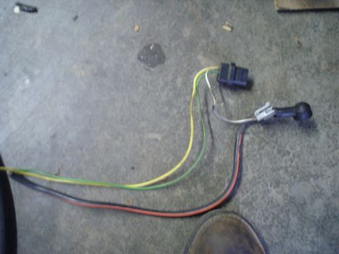 1984 Ford Bronco - Automotive wiring harness and sensor components on a concrete surface.