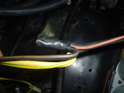 1984 Ford Bronco - Close-up of a vehicle's wiring harness, showing wires wrapped in black electrical tape.