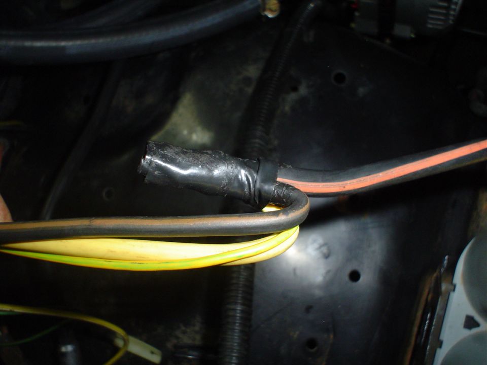 Wiring harness with black electrical tape and yellow wires