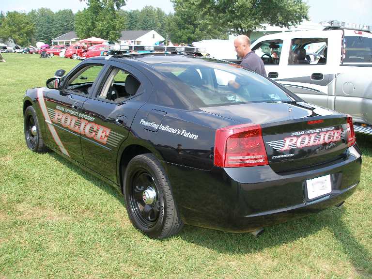 Black Dodge Charger police car with POLICE graphics, rear view at a car show