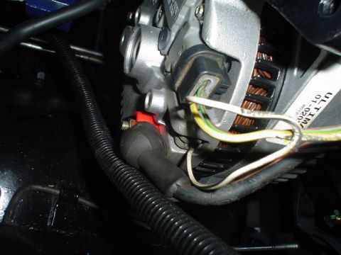 1984 Ford Bronco - Close-up of alternator wiring, showing a label with "ULTIMA" and part numbers.