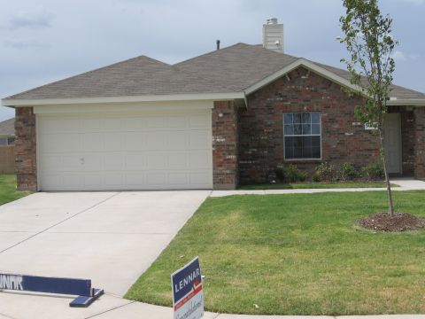 1983 Chevrolet Silverado 1500 - A suburban house with a well-maintained lawn and driveway.