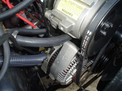 1984 Ford Bronco - Close-up view of engine components including an alternator and AC compressor with Gates belts.