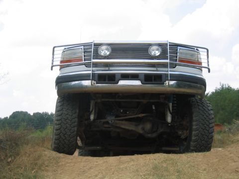 1996 Ford Bronco - Lifted 1996 Ford Bronco front view, showing brush guard and off-road tires.