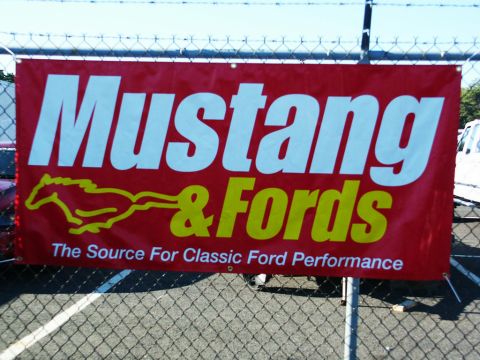 2001 Mercury Grand Marquis - A banner for Mustang & Fords is displayed at an outdoor event, with a chain-link fence in the foreground.