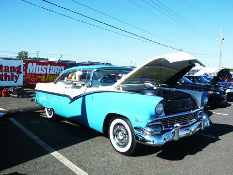 2001 Mercury Grand Marquis - Classic 1956 Ford Fairlane Crown Victoria on display at a car show with its hood open.