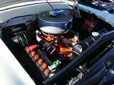 2001 Mercury Grand Marquis - The engine compartment features a vintage air cleaner with a miniature car on top and a red fluid bag.