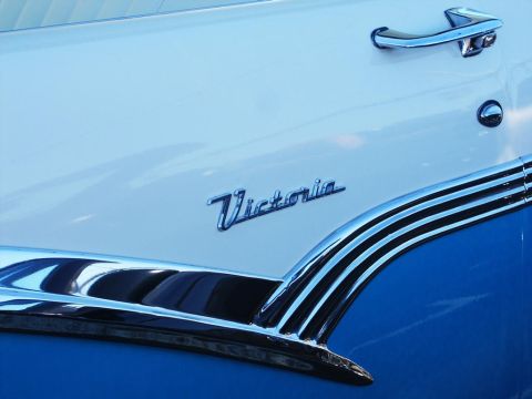 2001 Mercury Grand Marquis - Close-up of a 'Victoria' emblem on a classic car door.