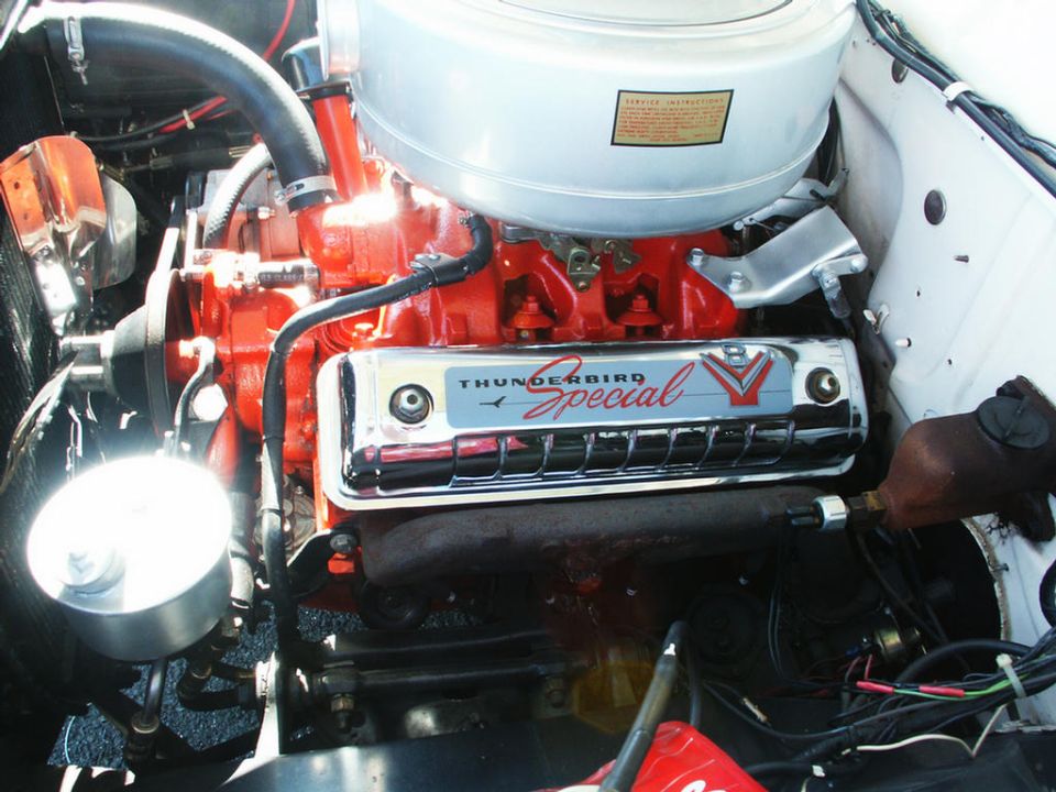 Engine bay detail showing a chrome valve cover with "Thunderbird Special" script and a V emblem