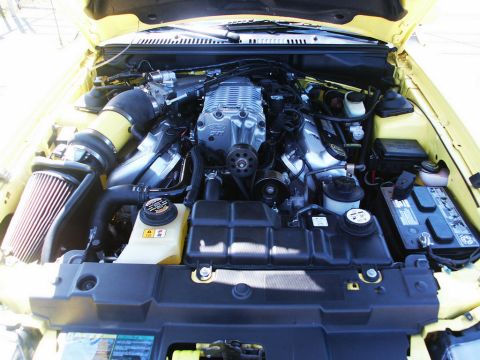2001 Mercury Grand Marquis - This yellow engine bay features a prominent supercharger and Ford badging, indicating a 2001 model year.
