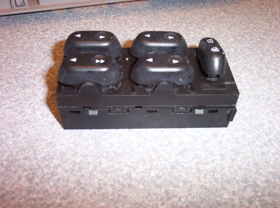 Black power window switch assembly with four window control buttons and one lock button