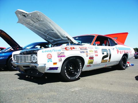 2001 Mercury Grand Marquis - A race car with its hood open, displaying numerous sponsor decals and the number 21.