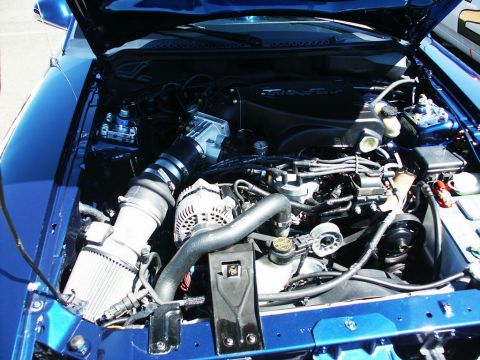 2001 Mercury Grand Marquis - Close-up view of a car's engine bay, showing various mechanical parts and wiring.