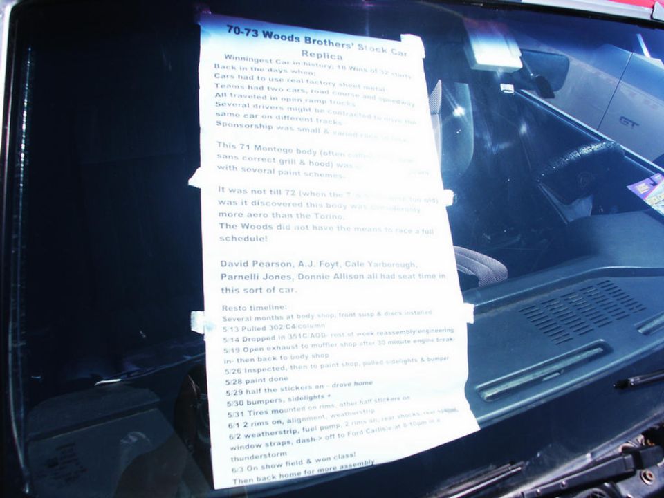 Paper on windshield details a 70-73 Woods Brothers' Black Car Replica, listing drivers and restoration timeline
