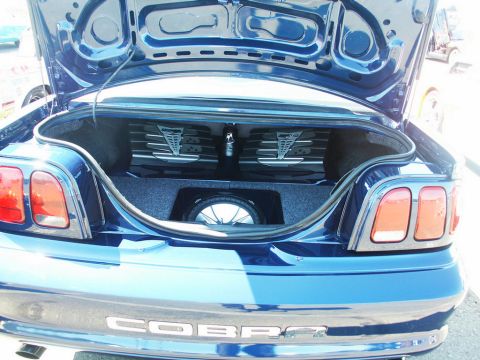 2001 Mercury Grand Marquis - Custom audio system installed in the trunk of a blue car, dual amplifiers and a subwoofer, with a 'COBRA' emblem on the rear.