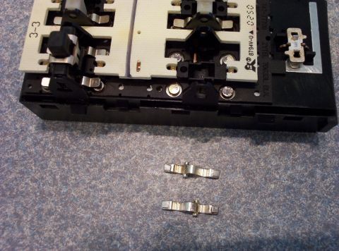 1998 Ford Crown Victoria - Close-up of an electrical connector housing and loose metal clips.