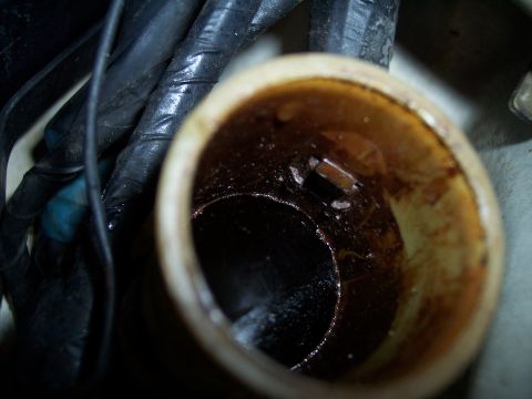 1995 Ford Probe - Engine oil filler cap opening shows significant buildup of dark, oily residue.