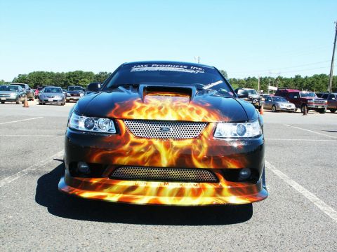 2001 Mercury Grand Marquis - This custom Ford Mustang features a striking flame graphic on its hood and front bumper, with a mesh grille and aftermarket hood scoop.
