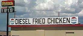 1968 Ford Mustang - Gas station sign shows prices and advertises Diesel Fried Chicken and Pepsi.