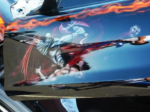 2001 Mercury Grand Marquis - A car door features a detailed airbrushed artwork depicting a violent fantasy scene with a warrior and flames.