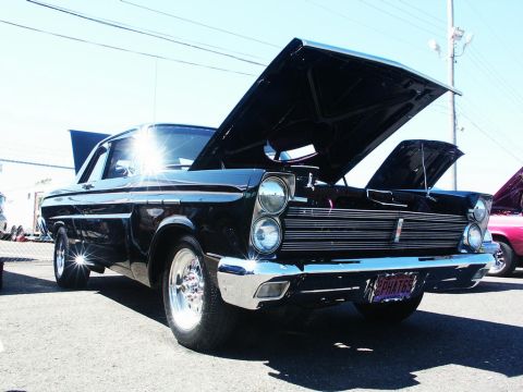 2001 Mercury Grand Marquis - A classic black Mercury Comet is displayed with its hood open at an outdoor event. The license plate reads 'PHATG5'.