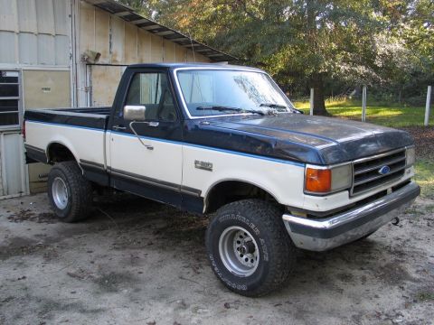 1989 Ford F-150 - This two-tone 1989 Ford F-150 pickup truck is shown from the front three-quarter view.