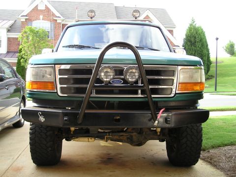 1996 Ford Bronco - Front view of a green 1996 Ford Bronco a custom bumper and auxiliary lights mounted on the grille guard.
