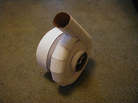1993 Ford Probe - A homemade model of a turbocharger, constructed from cardboard, sits on a carpeted surface.