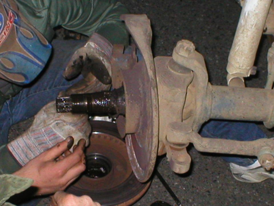 Front axle assembly with brake rotor and suspension components