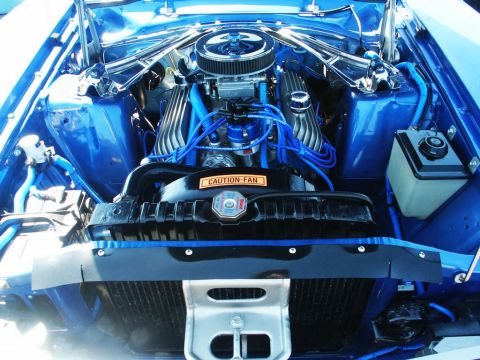 2001 Mercury Grand Marquis - Close-up of a custom blue engine bay with a V8 engine and various components visible.