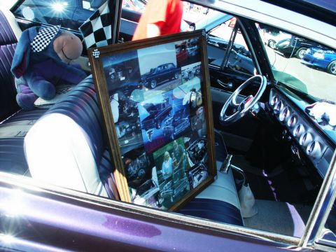 2001 Mercury Grand Marquis - Framed photo collage displayed inside a vintage car's interior, next to an Eeyore toy.
