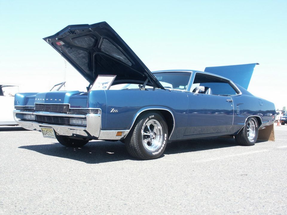 Blue Mercury coupe with hood and trunk open. Has chrome grille and bumpers, and aftermarket wheels